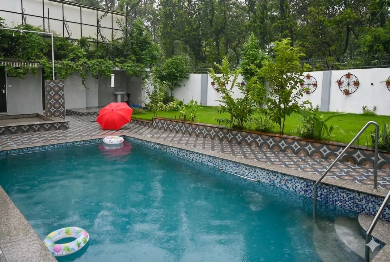 Clear blue swimming pool surrounded by nature in Uttarakhand